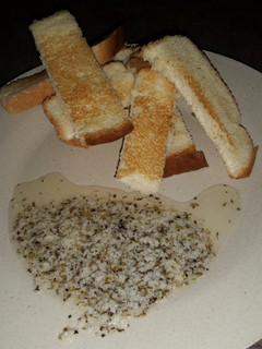 A picture of Sweet Parmesan Dipping Oil with Whole Wheat Bread.