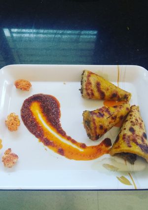 A picture of Cauliflower stuffed Paratha with schezwan sauce.