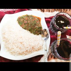 A picture of White rice with vegetable sauce.