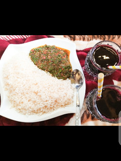 A picture of White rice with vegetable sauce.