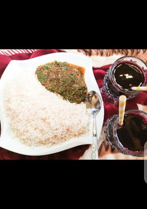 A picture of White rice with vegetable sauce.