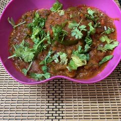 A picture of Stir fried veggies stuffed in capsicum gravy.
