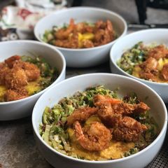 A picture of Coconut Shrimp w/ Leek Slaw over Cajun Grits.