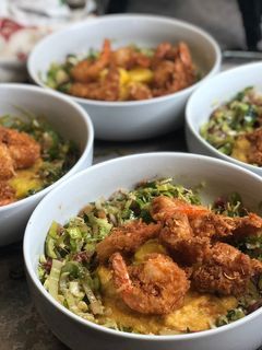 A picture of Coconut Shrimp w/ Leek Slaw over Cajun Grits.