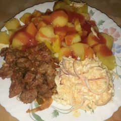 A picture of Baked potatoes served with wet fry and salad.