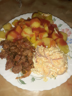 A picture of Baked potatoes served with wet fry and salad.