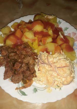 A picture of Baked potatoes served with wet fry and salad.