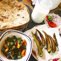 A picture of Bhindhi with tali hui sabz mirchain and thandi lassi.