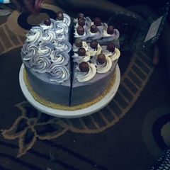 A picture of My cake slice topped with grapes 😋.