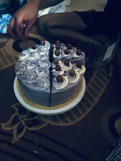 A picture of My cake slice topped with grapes 😋.