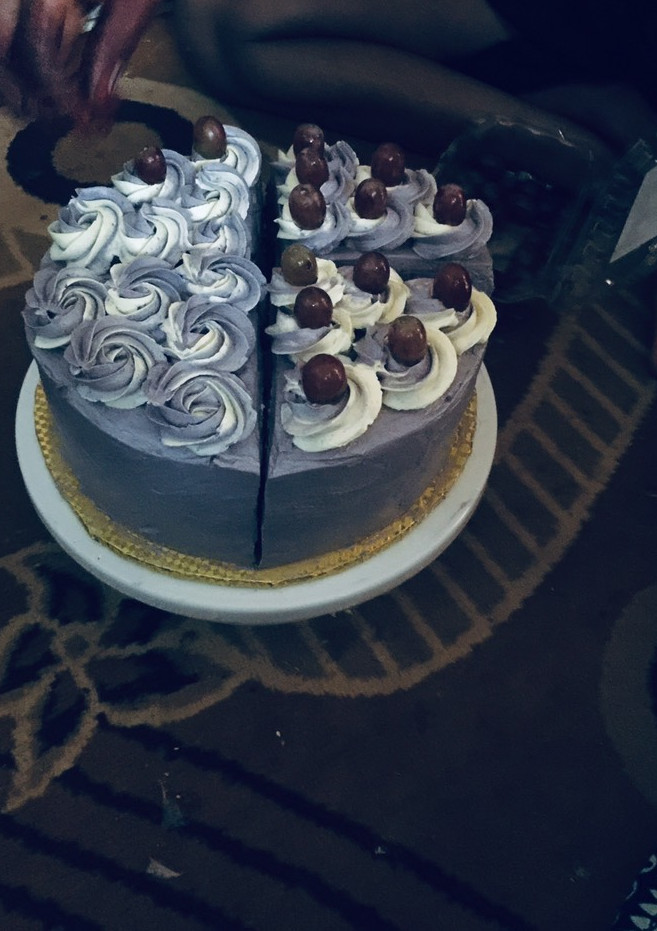 A picture of My cake slice topped with grapes 😋.