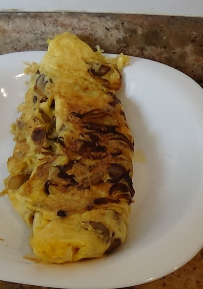 Una foto de Tortilla de cebolla y boletus