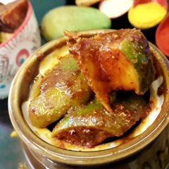 A picture of Mango pickle spicy and tangy.