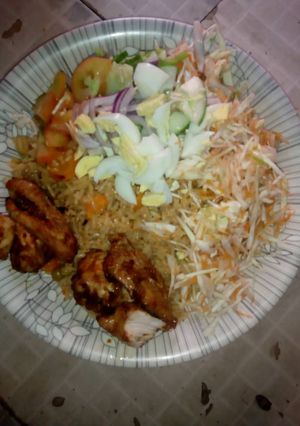 A picture of Jallof Rice with coslow n pepper chicken.