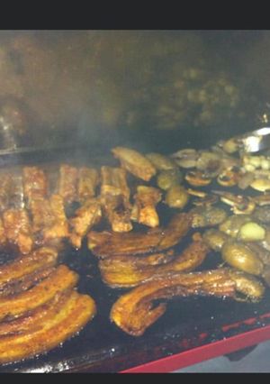 A picture of Grilled Pork Belly and Marinated Ribs with Potatoes, Zucchini, and Onions.