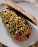 Gourmet Hot Dog with Caramelized Onions, Cheddar, Grilled Zucchini, Scrambled Egg, and Mustard