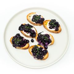 A picture of Roasted Thomcord Grape Toast with Whipped Ricotta, Honey, and Thyme.
