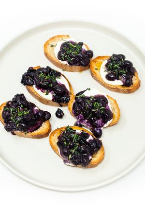 A picture of Roasted Thomcord Grape Toast with Whipped Ricotta, Honey, and Thyme.