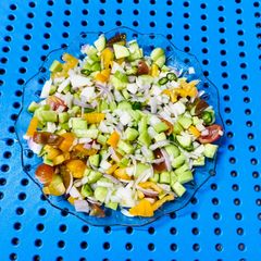 A picture of Chopped onion,Tomatoes and cucumber salad.