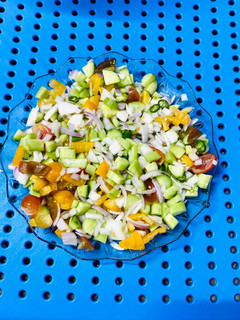 A picture of Chopped onion,Tomatoes and cucumber salad.
