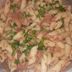 Penne in corned beef garnished with dhania A picture of Penne in corned beef garnished with dhania.