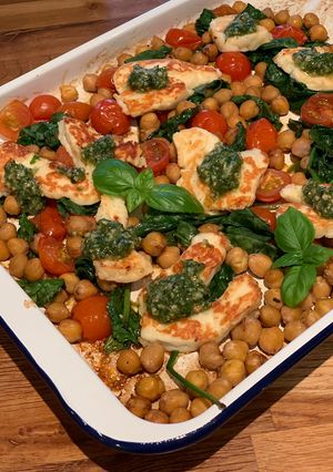 A picture of Halloumi with pesto, balsamic tomatoes, spinach and chickpeas.