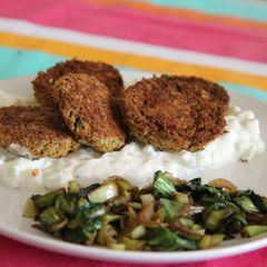 A picture of Oven baked felafel over Tzatziki-like sauce.