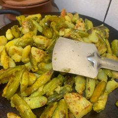 A picture of Crispy Aloo Kundri Tawa Fry (Potato and Ivy gourd).