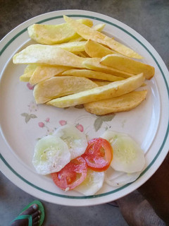 A picture of Chips and cucumber salad.