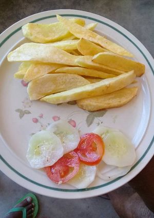 A picture of Chips and cucumber salad.