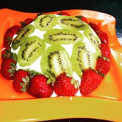 A picture of Lemon cake pudding with upside down kiwi whipped cream frosting.