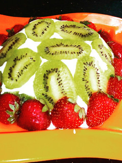 A picture of Lemon cake pudding with upside down kiwi whipped cream frosting.