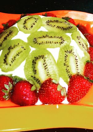 A picture of Lemon cake pudding with upside down kiwi whipped cream frosting.