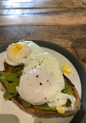 A picture of Poached egg and smashed avocado on toast.