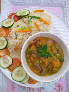 A picture of Coconut rice and lamb curry.