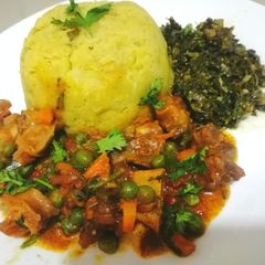 A picture of Mashed tumeric potatoe with meat stew.