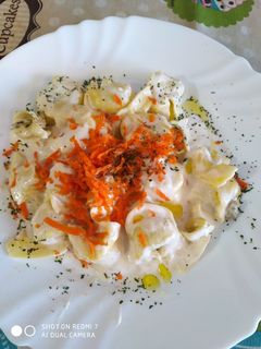 Una foto de Tortellinis de ricota y espinacas con nata