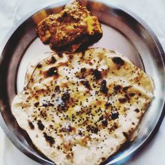 A picture of Paneer Butter Masala w/ Butter Naan.
