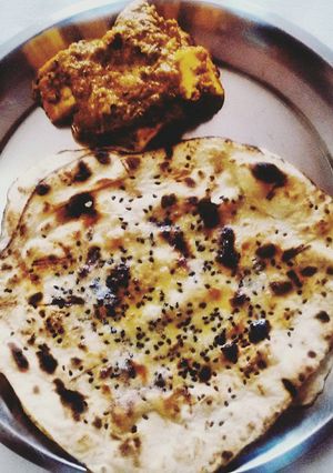 A picture of Paneer Butter Masala w/ Butter Naan.