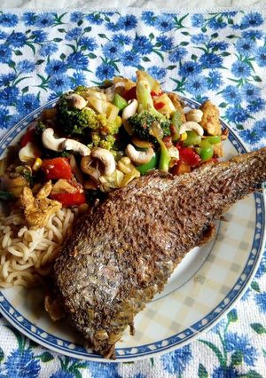 A picture of Thai chicken and fish vegetable stir fry.