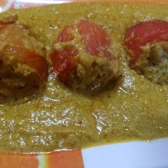A picture of Stuffed tomato with gravy.