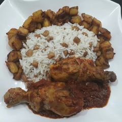 A picture of Beans,rice,fried plantain and chicken.