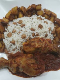 A picture of Beans,rice,fried plantain and chicken.