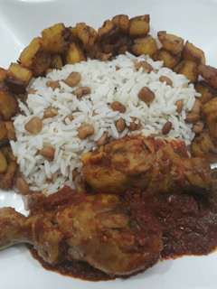 A picture of Beans,rice,fried plantain and chicken.