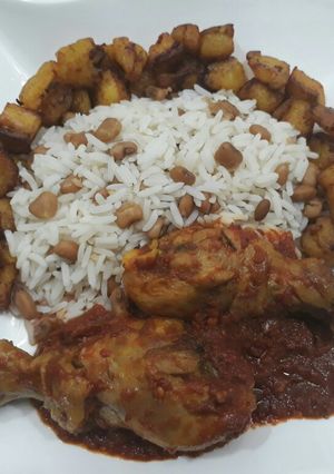 A picture of Beans,rice,fried plantain and chicken.