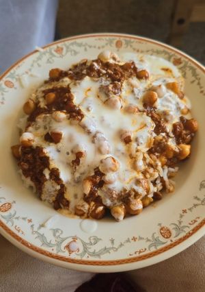 A picture of Beef and chickpea rogan josh with rice and yoghurt.