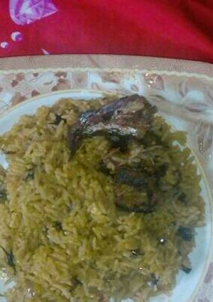 A picture of Jollof rice wit curry leaf.