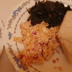 A picture of Ugali, Scrambled Eggs and Greens.