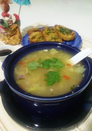 A picture of Chicken soup with garlic bread.