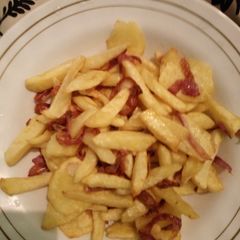 A picture of Deep Fried potatoes with onions.